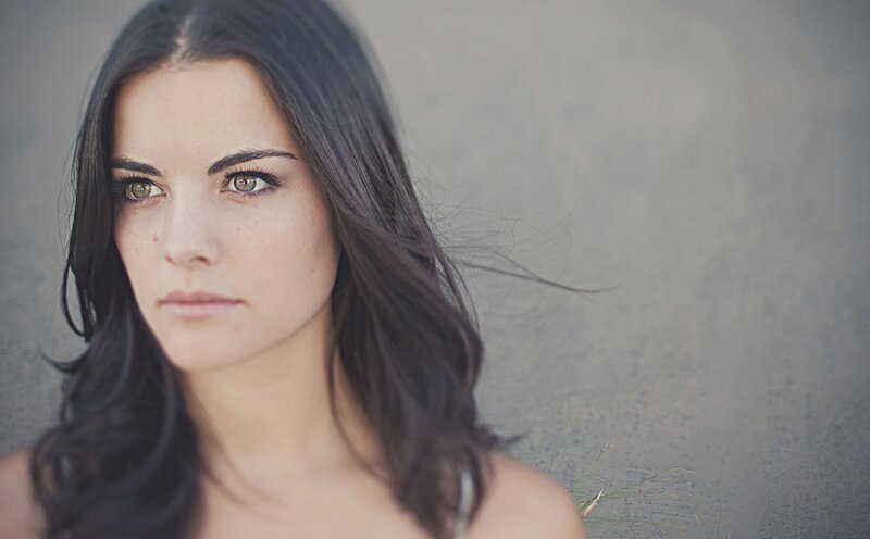 woman with dark hair and green eyes