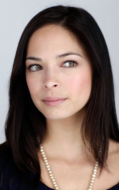 woman with dark hair and green eyes