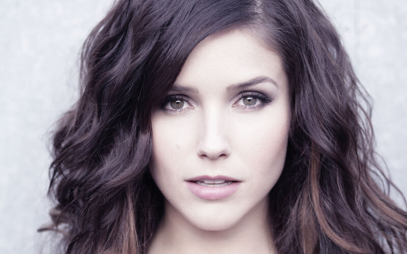 woman with dark hair and green eyes