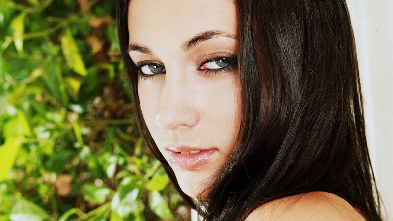 woman with dark hair and green eyes