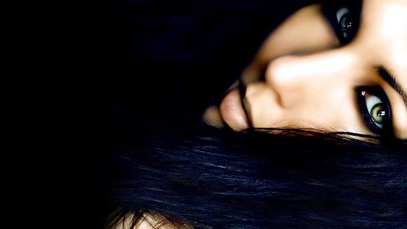 woman with dark hair and green eyes