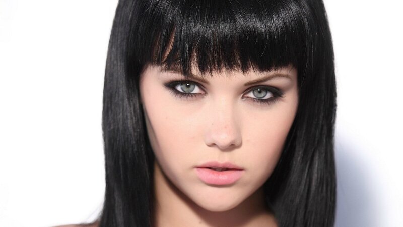 woman with dark hair and green eyes
