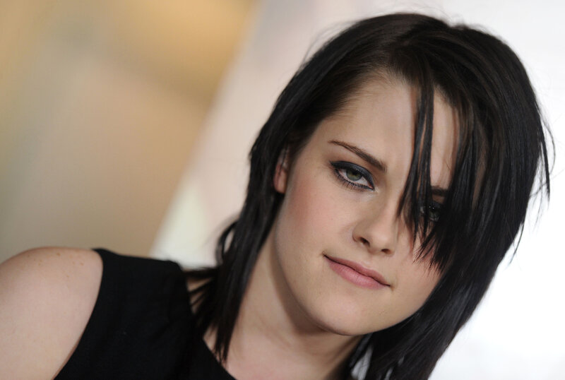 woman with dark hair and green eyes