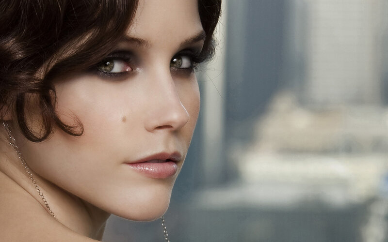 woman with dark hair and green eyes