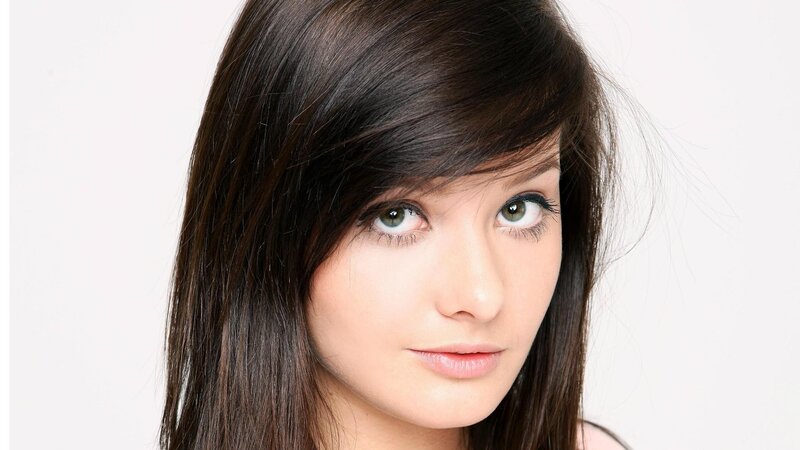 woman with dark hair and green eyes