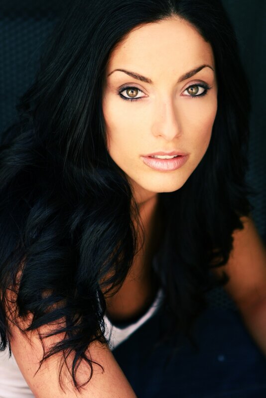 woman with dark hair and green eyes