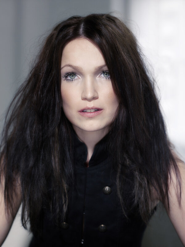 woman with dark hair and green eyes