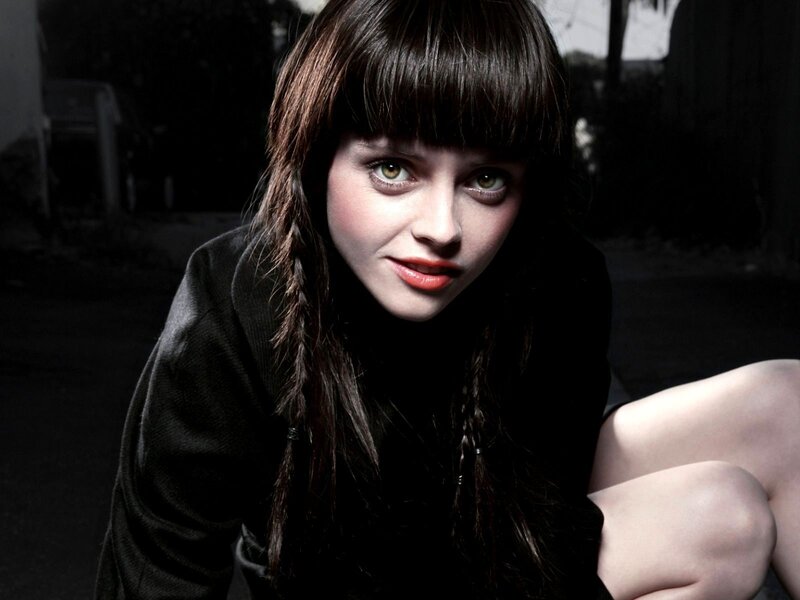 woman with dark hair and green eyes