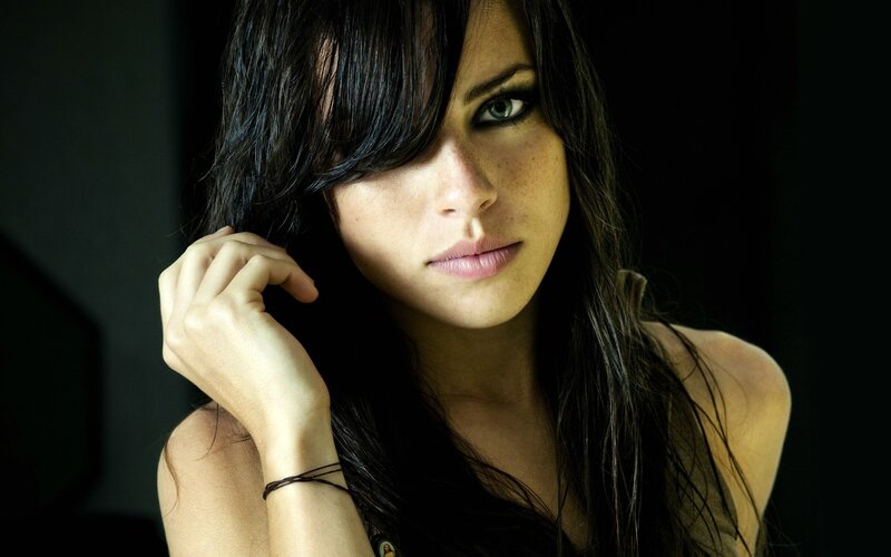 woman with dark hair and green eyes