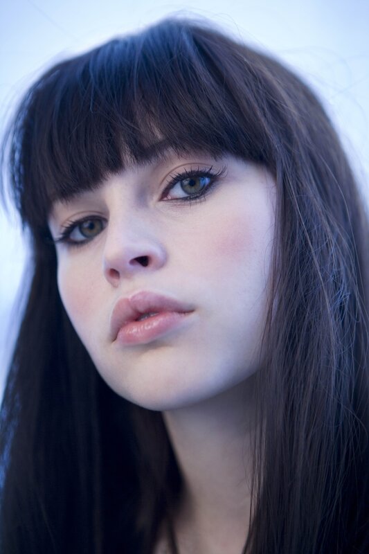 woman with dark hair and green eyes
