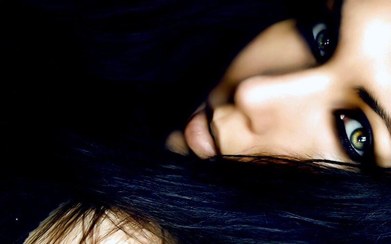 woman with dark hair and green eyes