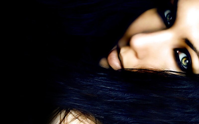 woman with dark hair and green eyes