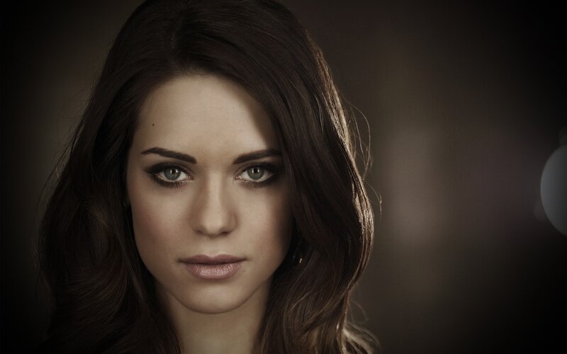 woman with dark hair and green eyes
