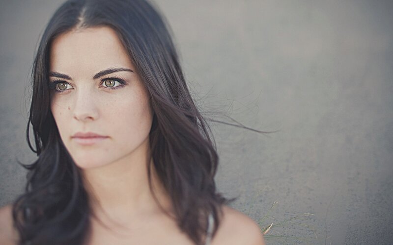 woman with dark hair and green eyes