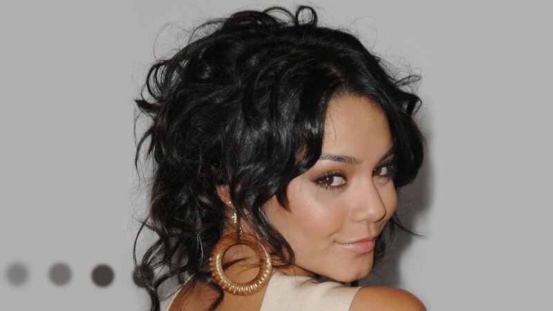 woman with dark hair and hoop earrings