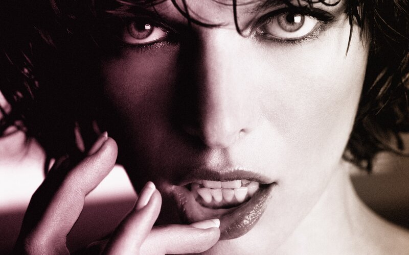 woman with dark hair and intense gaze