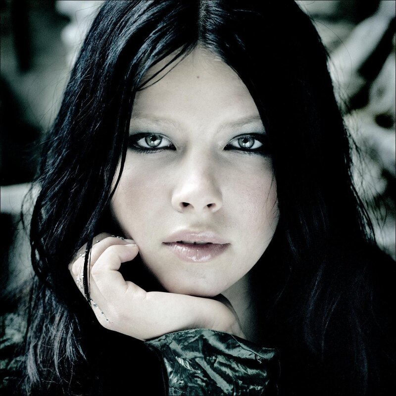 woman with dark hair and intense gaze