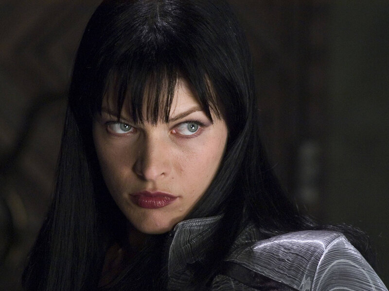 Woman with dark hair and intense gaze