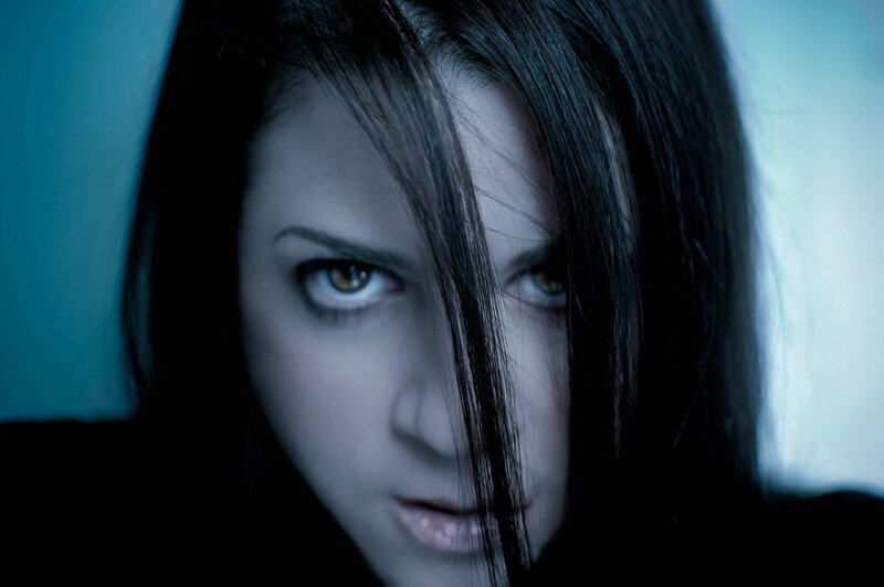 woman with dark hair and intense gaze