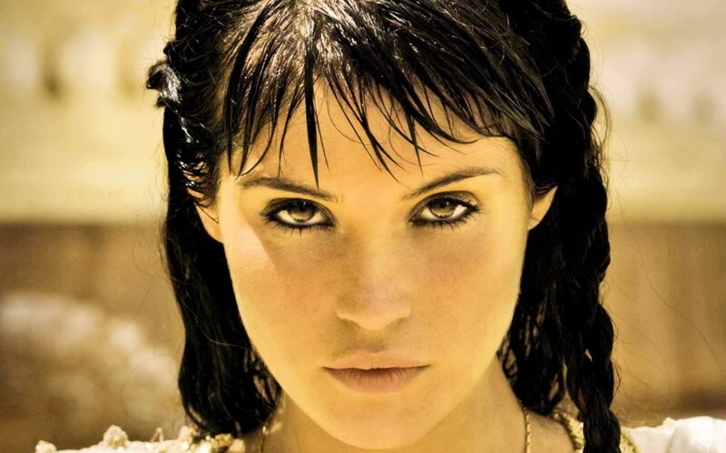 woman with dark hair and intense gaze