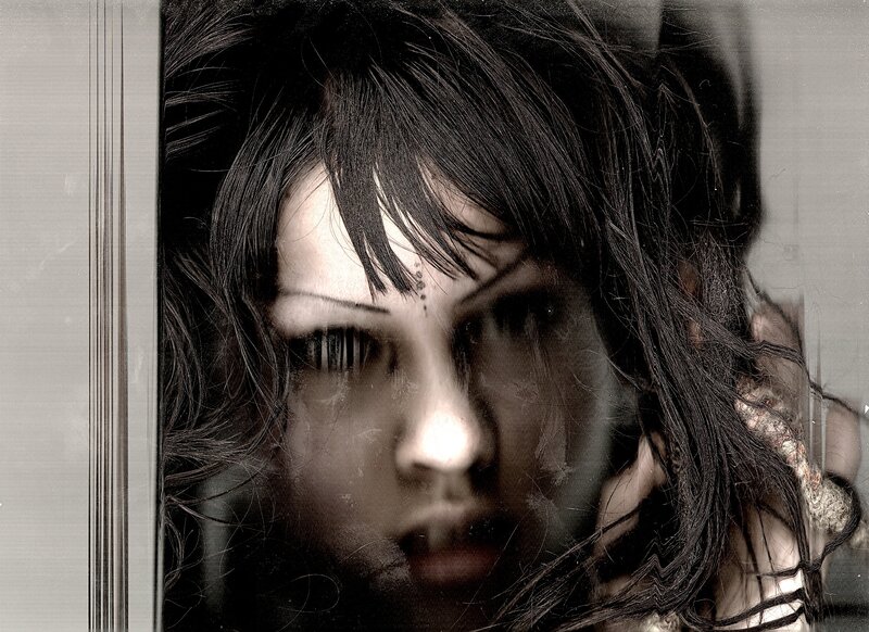 woman with dark hair and intense gaze