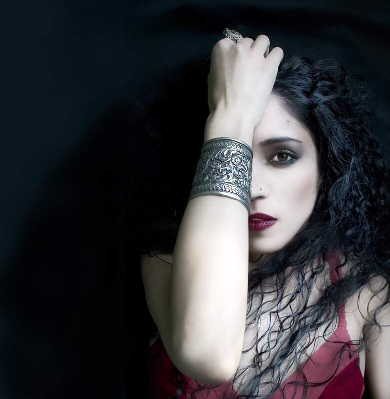 woman with dark hair and jewelry