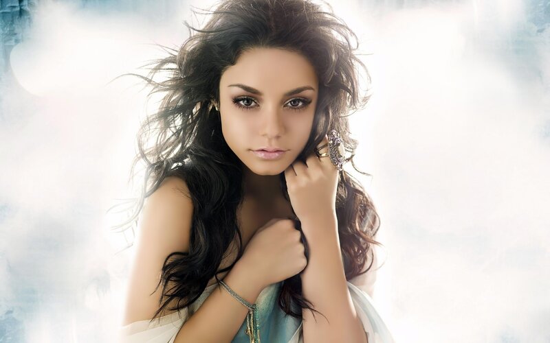 woman with dark hair and jewelry
