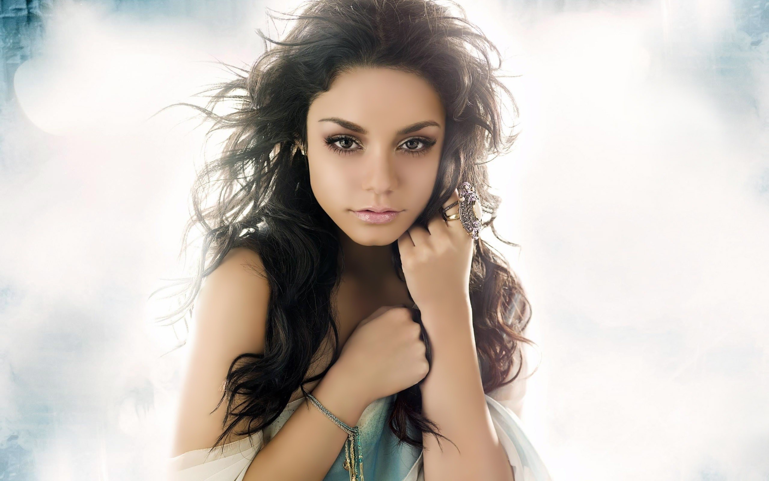 woman with dark hair and jewelry