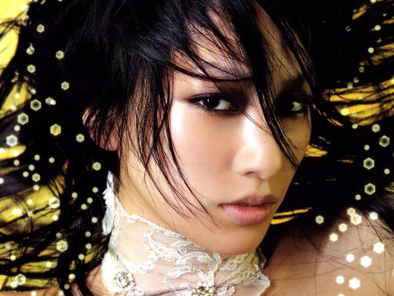 woman with dark hair and lace collar