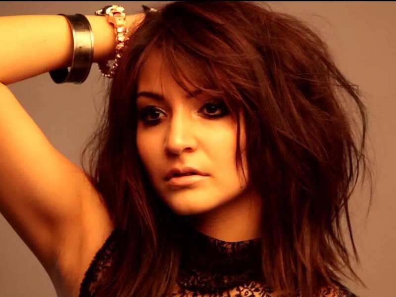 woman with dark hair and lace top
