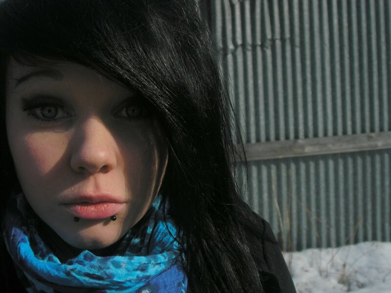woman with dark hair and lip piercings