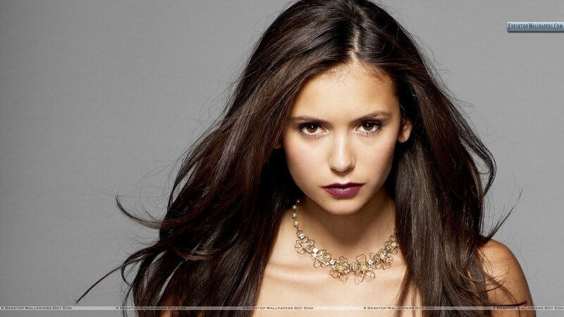 woman with dark hair and necklace