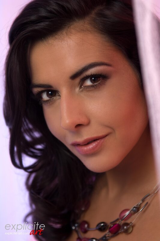 woman with dark hair and necklace