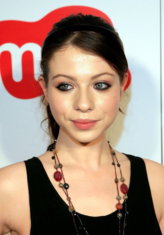 woman with dark hair and necklace