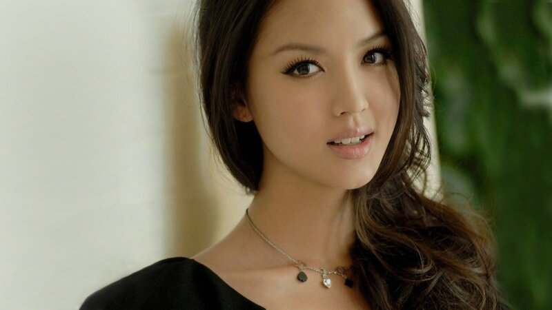 woman with dark hair and necklace