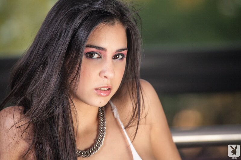 woman with dark hair and necklace