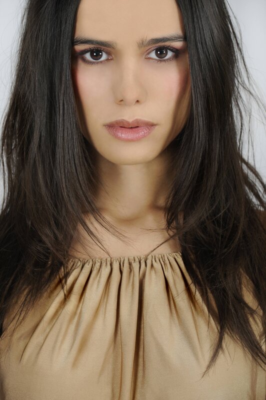 woman with dark hair and neutral expression