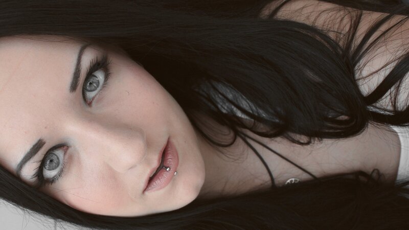 woman with dark hair and piercing