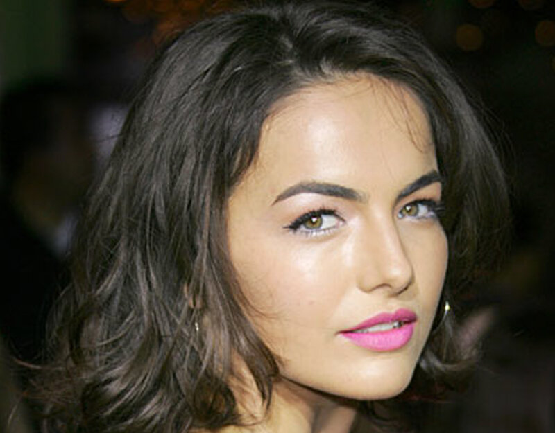woman with dark hair and pink lipstick