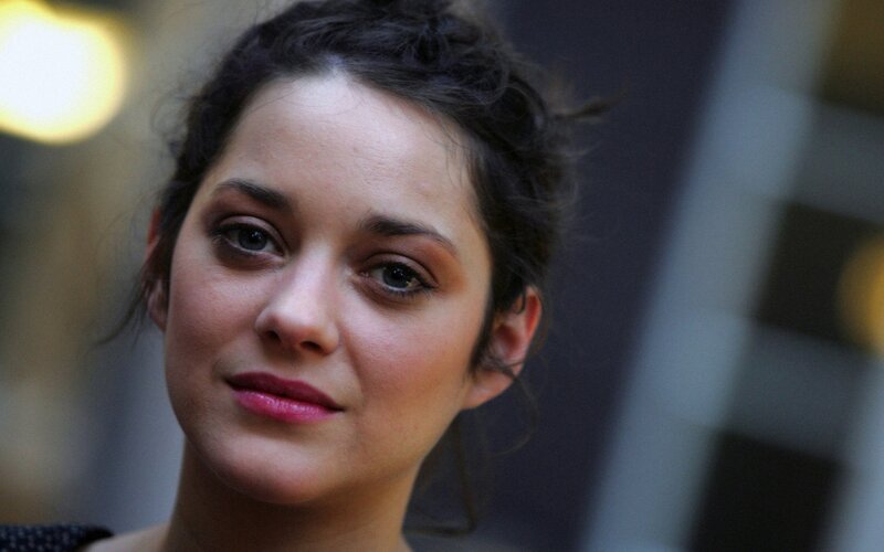 woman with dark hair and pink lipstick