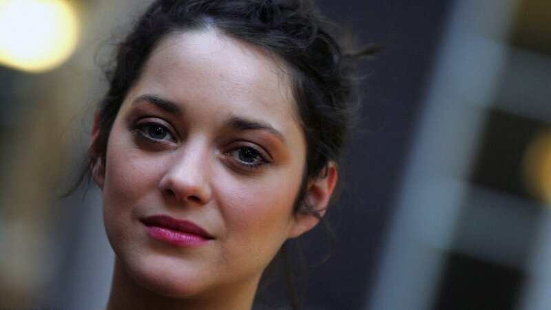 woman with dark hair and pink lipstick
