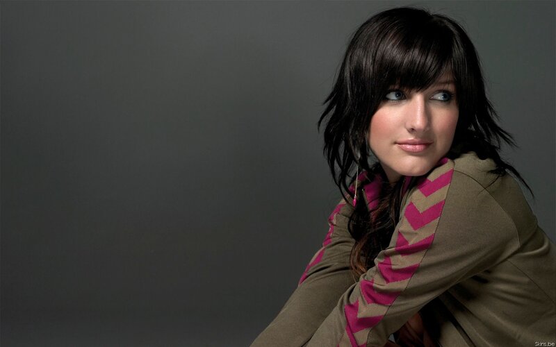 woman with dark hair and pink scarf