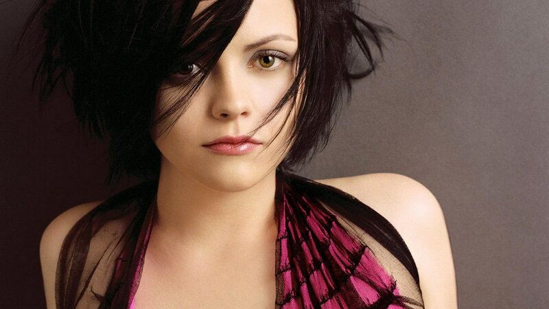woman with dark hair and pink top