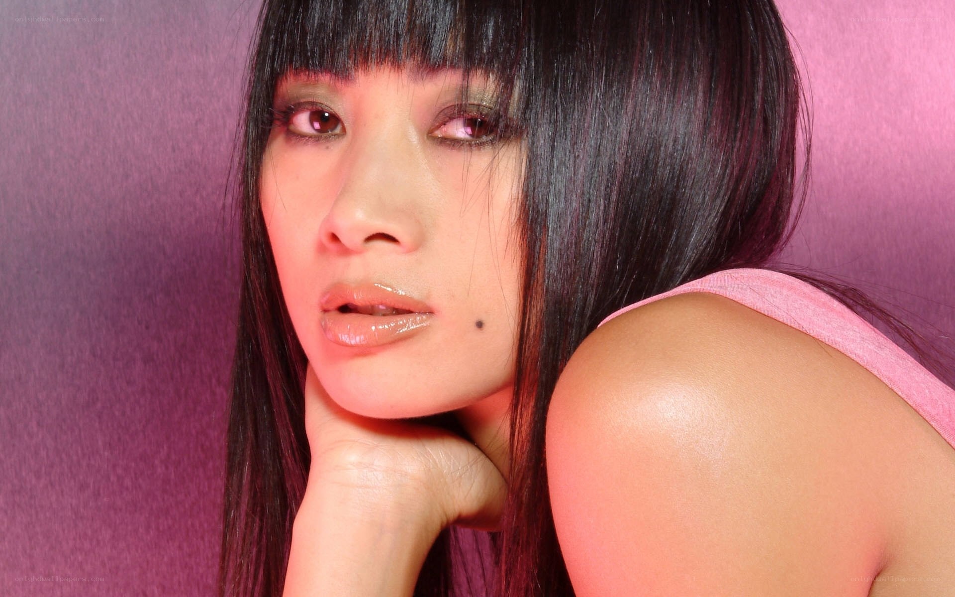 woman with dark hair and pink top