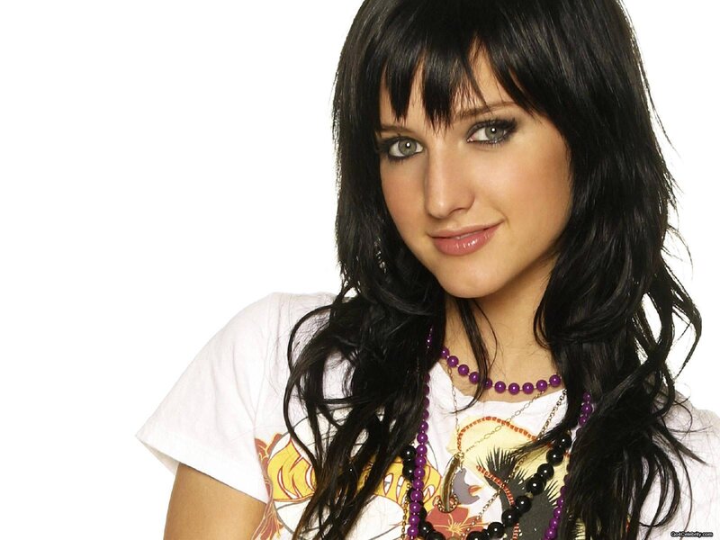woman with dark hair and purple beads