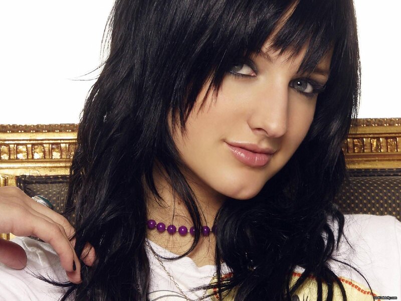woman with dark hair and purple beads