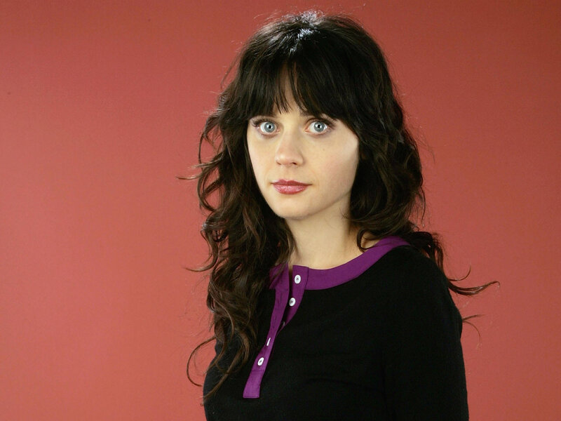 woman with dark hair and purple collar