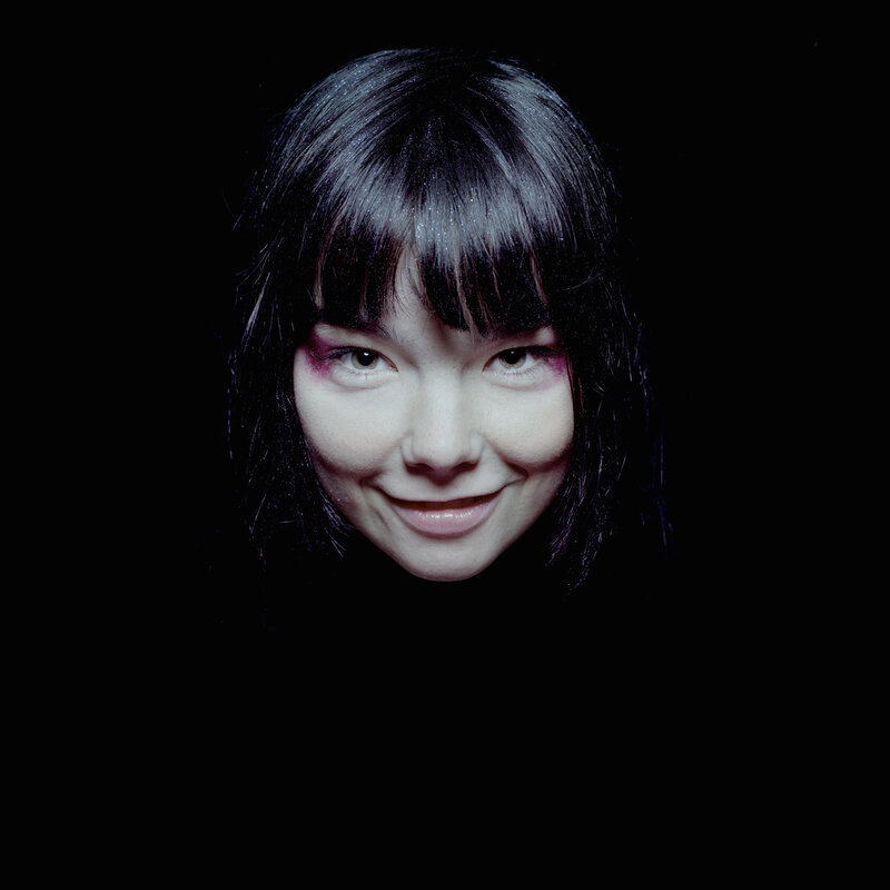 woman with dark hair and purple makeup