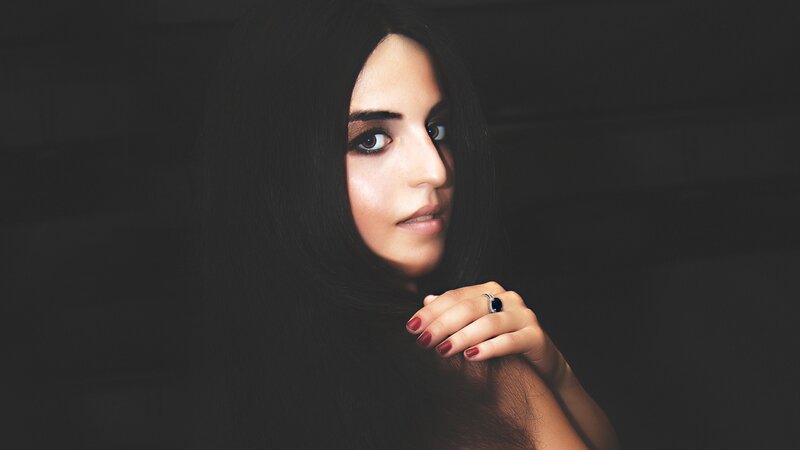 woman with dark hair and ring