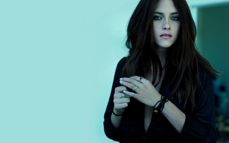 woman with dark hair and rings